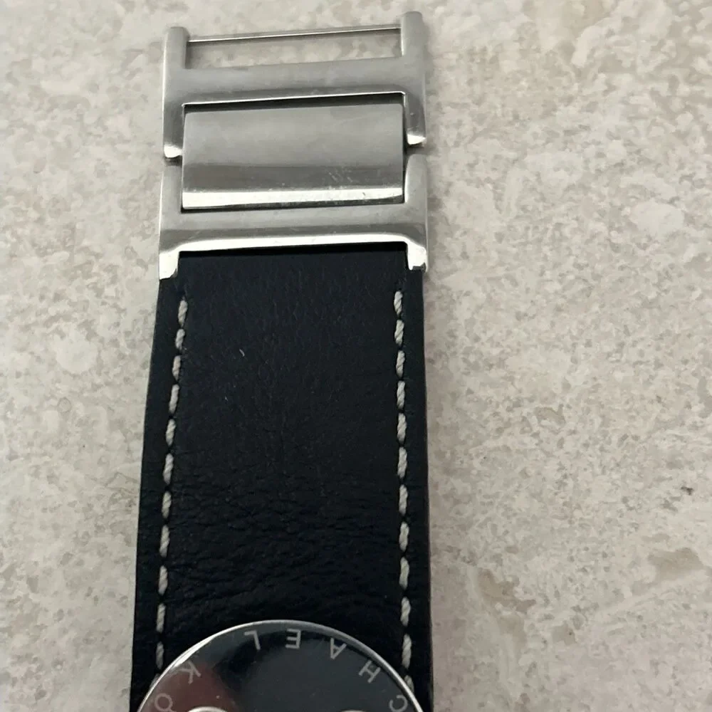 Michael Kors Women’s Rectangle Quartz Watch Silver Dial Black Leather Strap Date